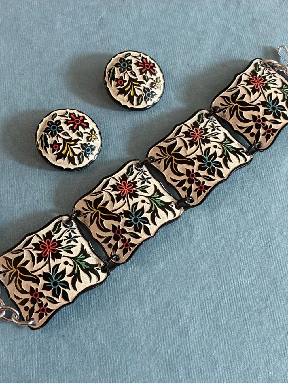 West Germany floral relief enameled bracelet and clip earrings set on beige